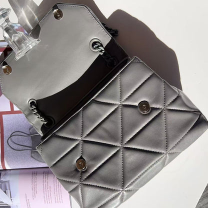 Gray quilted handbag with gold accents on a light background