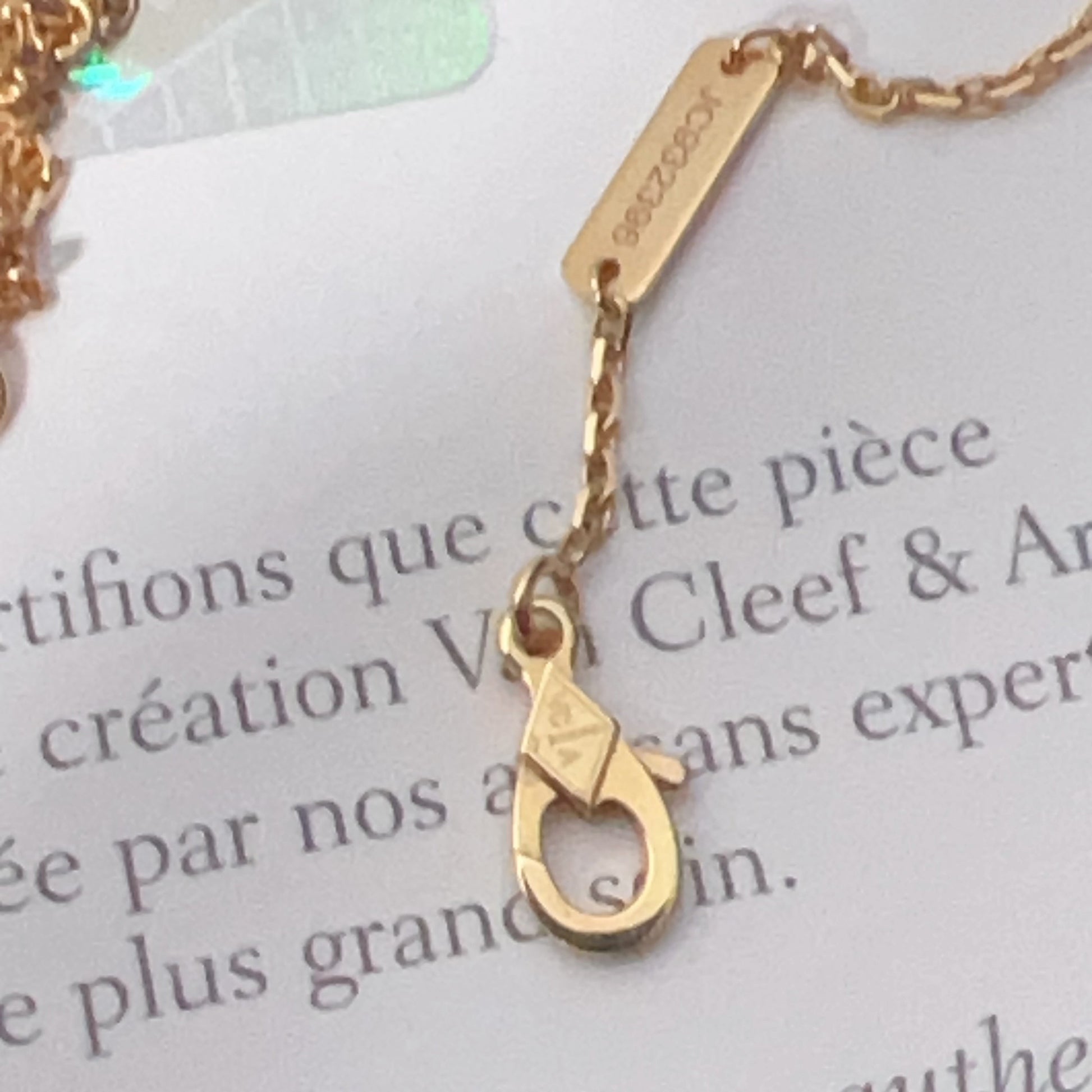 Gold necklace with a clasp on a brand card
