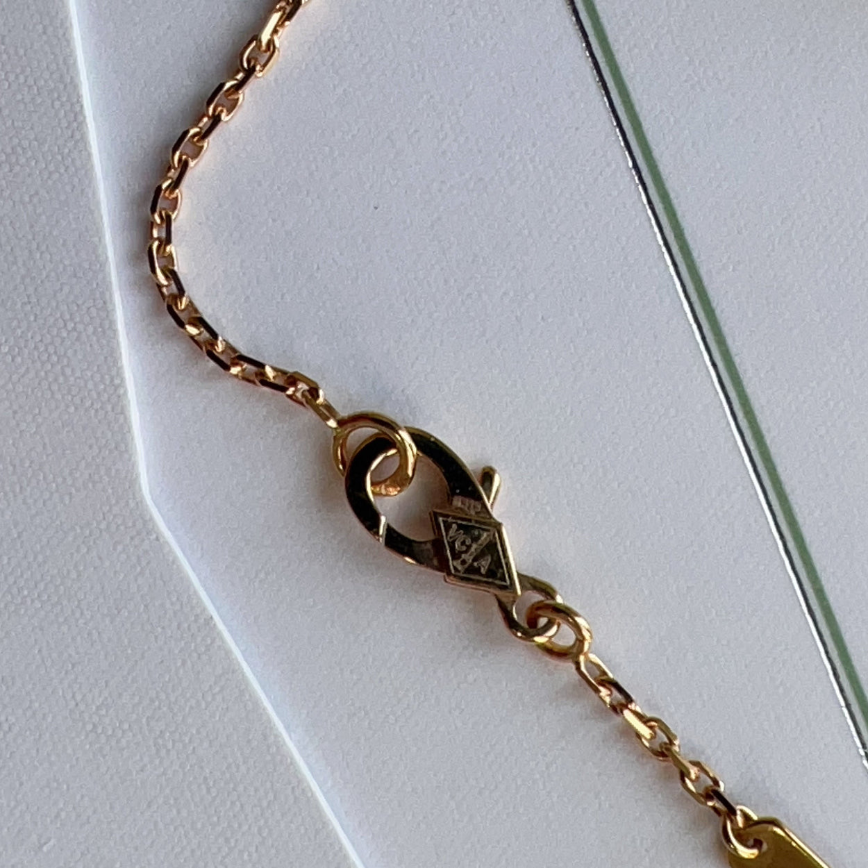 Gold bracelet with clasp on a white background