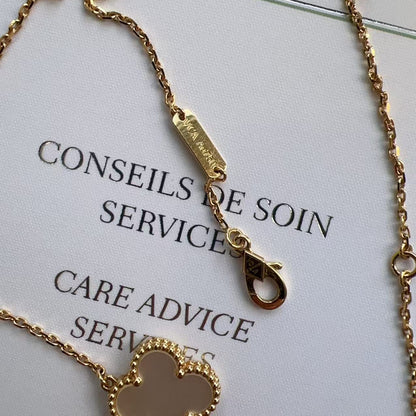 Gold bracelet with heart pendant on a care advice card