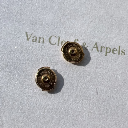 Gold earrings on a Van Cleef & Arpels branded card