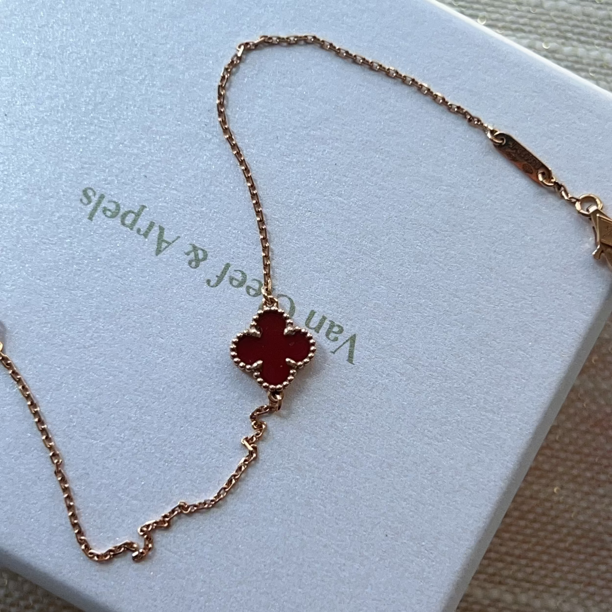 Van Cleef & Arpels necklace with clover pendant on a branded box